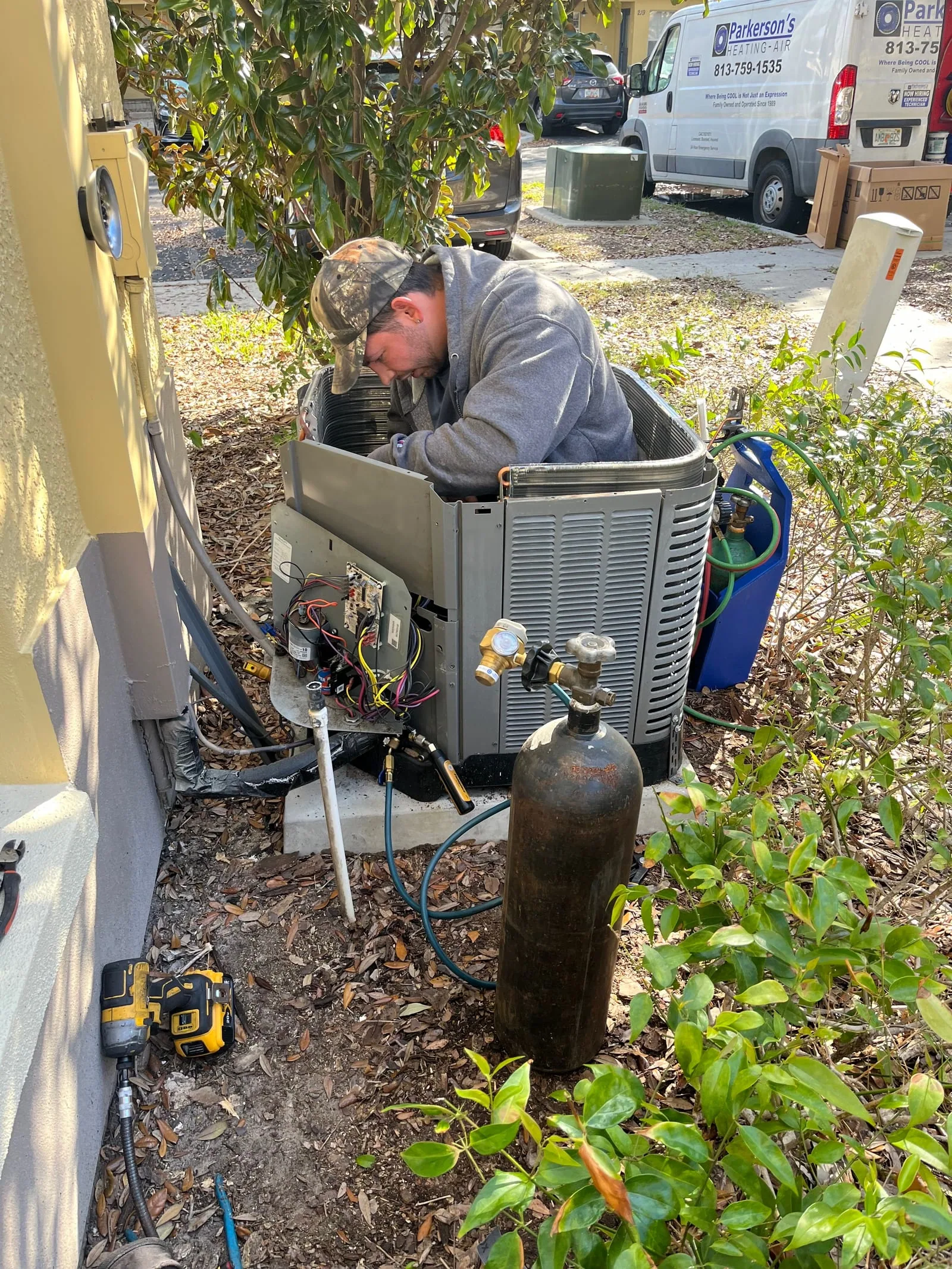 Parkersons HVAC technician diagnosing system issues using professional equipment